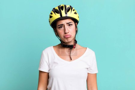Photo for Feeling sad and whiney with an unhappy look and crying. bike helmet concept - Royalty Free Image