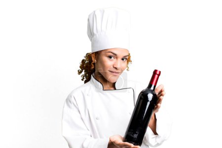 Téléchargez les photos : Red hair pretty chef woman holding a wine bottle - en image libre de droit