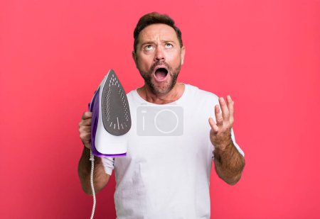 Photo for Middle age man looking desperate, frustrated and stressed. housekeeper concept - Royalty Free Image