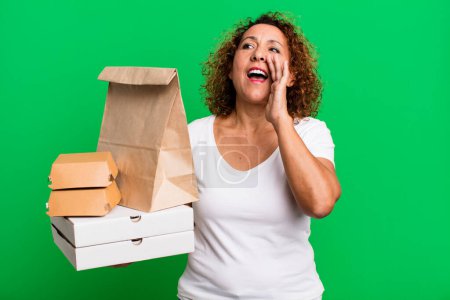 Photo for Feeling happy,giving a big shout out with hands next to mouth. take away fast food delivery concept. - Royalty Free Image