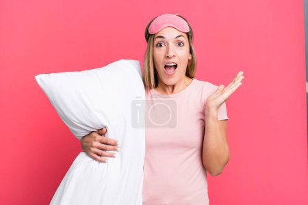 Photo for Pretty blonde woman feeling happy and astonished at something unbelievable. pajamas or nightwear concept - Royalty Free Image