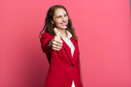 Photo for Hispanic pretty woman feeling proud,smiling positively with thumbs up. telemarketing concept - Royalty Free Image