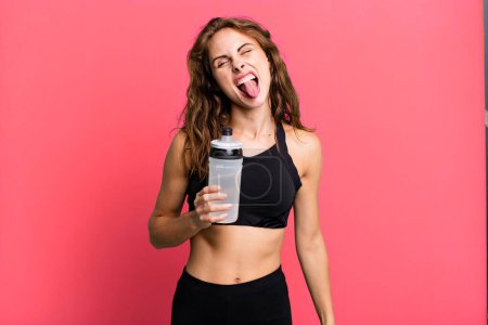 Foto de Hispanic pretty woman with cheerful and rebellious attitude, joking and sticking tongue out. fitness and exercise concept - Imagen libre de derechos
