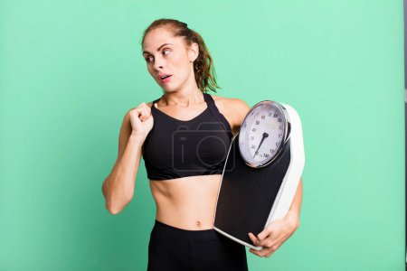 Téléchargez les photos : Hispanic pretty woman feeling stressed, anxious, tired and frustrated. fitness, diet and weight scale concept - en image libre de droit