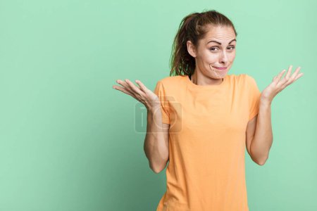 Photo for Hispanic pretty woman feeling puzzled and confused and doubting. copy space concept - Royalty Free Image