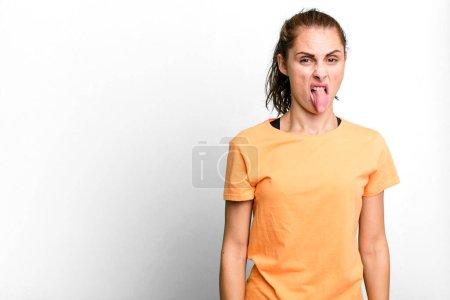 Photo for Hispanic pretty woman feeling disgusted and irritated and tongue out. copy space concept - Royalty Free Image