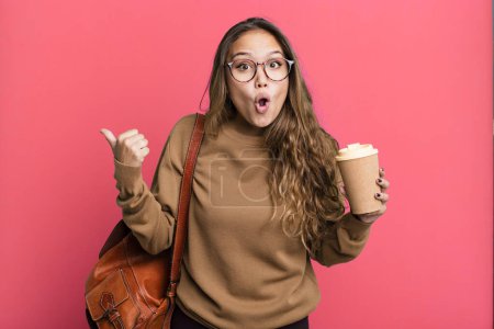 Photo for Hispanic pretty woman looking astonished in disbelief. take away coffee concept - Royalty Free Image