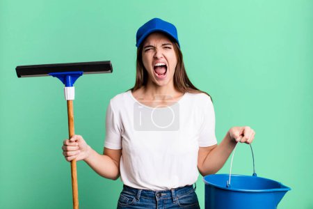 Téléchargez les photos : Young pretty woman housekeeper cleaning the windows - en image libre de droit