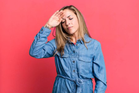 Photo for Blonde adult woman looking stressed, tired and frustrated, drying sweat off forehead, feeling hopeless and exhausted - Royalty Free Image