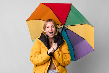 Photo for Pretty caucasian woman with a umbrella and an anorak - Royalty Free Image