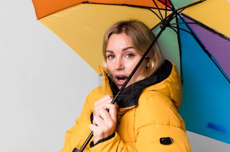 Foto de Pretty caucasian woman with a umbrella and an anorak - Imagen libre de derechos