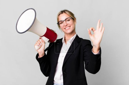 Photo for Pretty caucasian business blonde woman with a megaphone - Royalty Free Image
