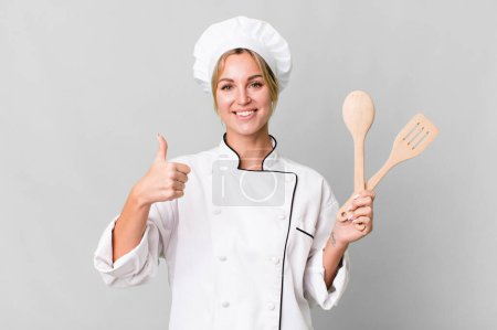 Foto de Pretty caucasian restaurant chef woman with wooden tool - Imagen libre de derechos