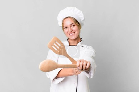Photo for Pretty caucasian restaurant chef woman with wooden tool - Royalty Free Image