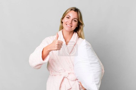Photo for Pretty caucasian woman wearing night wear and a pillow - Royalty Free Image
