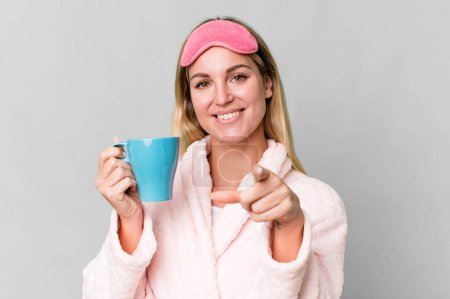 Foto de Pretty caucasian woman wearing night wear and having a coffee cup for breakfast - Imagen libre de derechos