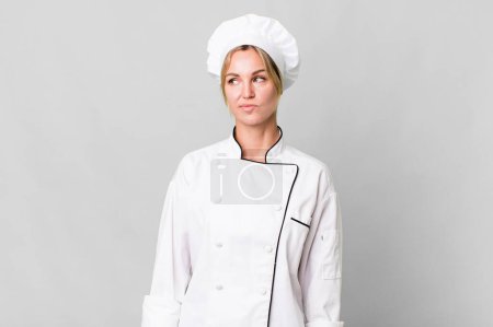Téléchargez les photos : Caucasian blonde woman feeling sad, upset or angry and looking to the side. chef concept - en image libre de droit