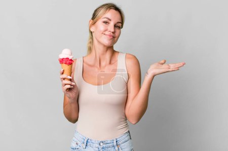 Photo for Caucasian blonde woman feeling puzzled and confused and doubting. ice cream concept - Royalty Free Image