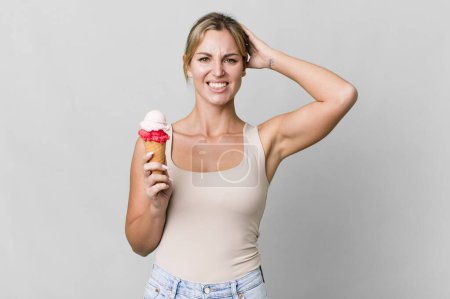 Photo for Caucasian blonde woman feeling stressed, anxious or scared, with hands on head. ice cream concept - Royalty Free Image