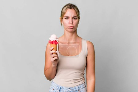 Photo for Caucasian blonde woman feeling sad and whiney with an unhappy look and crying. ice cream concept - Royalty Free Image