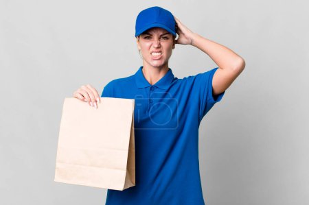 Photo for Caucasian blonde woman feeling stressed, anxious or scared, with hands on head. paper bag delivery concept - Royalty Free Image