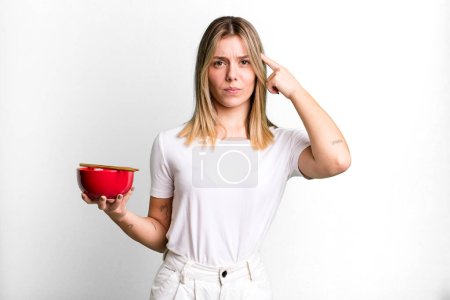 Photo for Young pretty woman feeling confused and puzzled, showing you are insane. japanese ramen noodles concept - Royalty Free Image