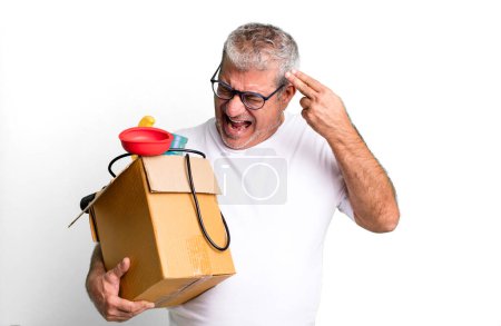 Photo for Middle age senior man looking unhappy and stressed, suicide gesture making gun sign. housekeeper repairman with a toolbox concept - Royalty Free Image