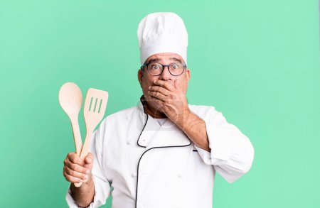Photo for Middle age senior man covering mouth with hands with a shocked. restaurant chef with a tool concept - Royalty Free Image