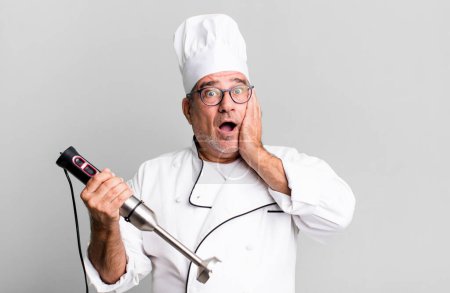Photo for Middle age senior man feeling happy, excited and surprised. restaurant chef with a tool concept - Royalty Free Image