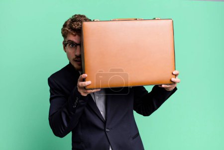 Téléchargez les photos : Young adult caucasian businessman with a suit case - en image libre de droit