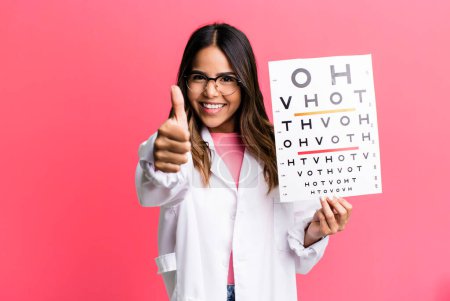 Photo for Hispanic pretty woman feeling proud,smiling positively with thumbs up. optometry concept - Royalty Free Image