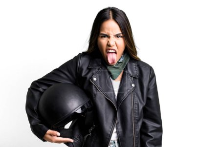 Photo for Hispanic pretty woman feeling disgusted and irritated and tongue out. motorbike rider concept - Royalty Free Image