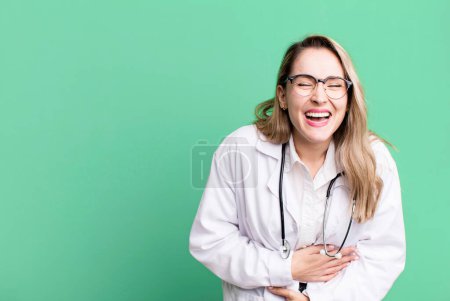 Téléchargez les photos : Laughing out loud at some hilarious joke. medicine student or physician - en image libre de droit