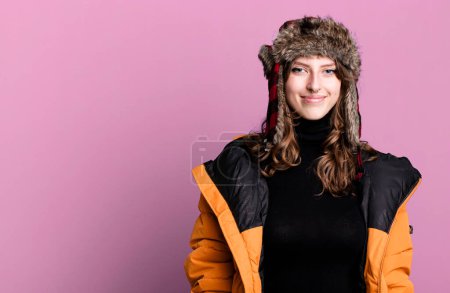 Photo for Caucasian pretty blonde woman wearing anorak and hat. winter and cold concept - Royalty Free Image
