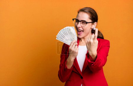 Foto de Young adult pretty businesswoman with dollar banknotes. money concept - Imagen libre de derechos