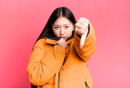 Foto de Young adult pretty asian woman wearing anorak. winter and cold concept - Imagen libre de derechos