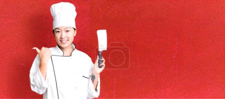 Téléchargez les photos : Jeune adulte jolie femme asiatique. chef de restaurant avec un couteau - en image libre de droit