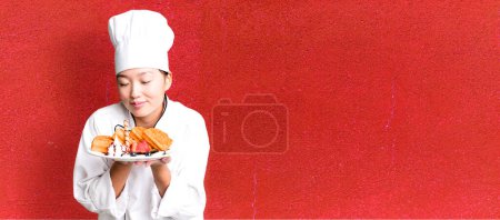 Téléchargez les photos : Jeune adulte jolie femme asiatique. chef restaurant avec gaufres pour le petit déjeuner - en image libre de droit