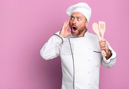 Téléchargez les photos : Middle age man feeling happy, excited and surprised. chef and tools concept - en image libre de droit