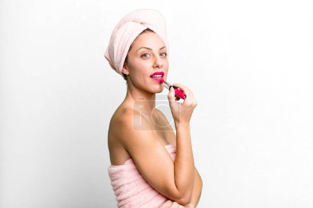 Téléchargez les photos : Young pretty woman making up and holding a lipstick - en image libre de droit