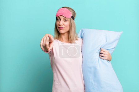 Photo for Pretty blonde woman pointing at camera choosing you. pajamas and nightwear concept - Royalty Free Image