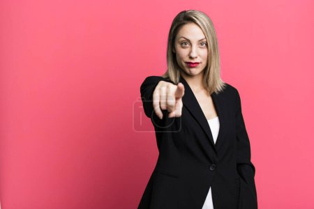 Foto de Pretty blonde woman pointing at camera choosing you. businesswoman concept - Imagen libre de derechos