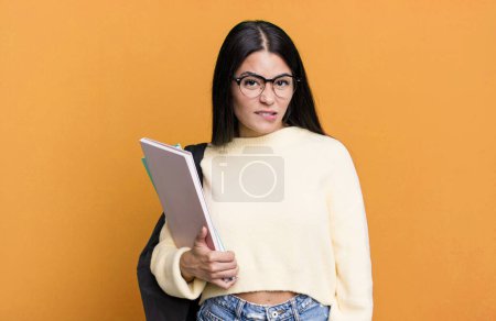 Foto de Mujer bonita hispana mirando perpleja y confundida. concepto de estudiante universitario - Imagen libre de derechos