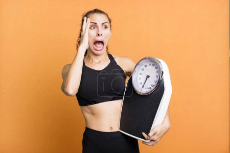 Photo for Hispanic pretty woman feeling happy, excited and surprised. fitness, diet and weight scale concept - Royalty Free Image
