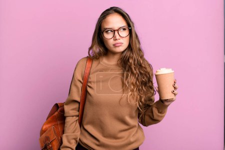 Photo for Hispanic pretty woman feeling sad, upset or angry and looking to the side. take away coffee concept - Royalty Free Image