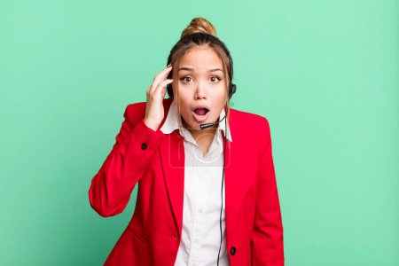 Photo for Hispanic pretty woman looking surprised, realizing a new thought, idea or concept. telemarketing concept - Royalty Free Image