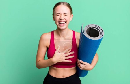 Foto de Caucasian pretty woman laughing out loud at some hilarious joke. fitness and yoga concept - Imagen libre de derechos