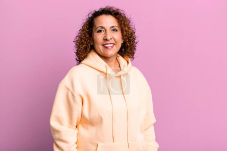Photo for Middle age hispanic woman smiling cheerfully and casually with a positive, happy, confident and relaxed expression - Royalty Free Image
