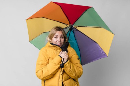 Photo for Pretty caucasian woman with a umbrella and an anorak - Royalty Free Image