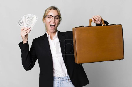 Photo for Pretty caucasian businesswoman with a leather suit case - Royalty Free Image